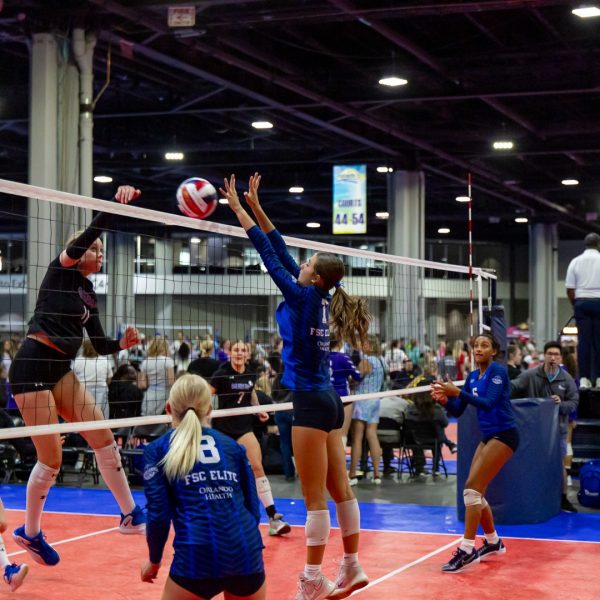 Prep and Developmental Volleyball 30 A volleyball player strikes the ball with her hand during a match, showcasing her athleticism and focus.
