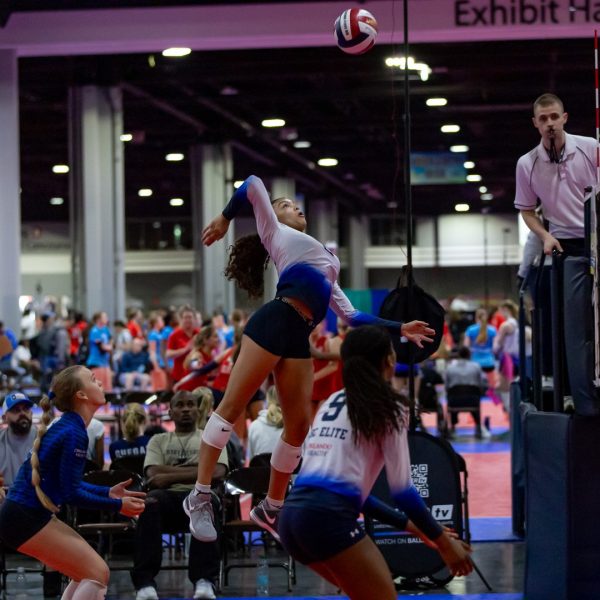 Prep and Developmental Volleyball 32 A volleyball player strikes the ball with her hand during a match, showcasing her athleticism and focus.
