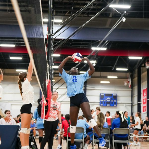 Prep and Developmental Volleyball 29 A volleyball player strikes the ball with her hand during a match, showcasing her athleticism and focus.