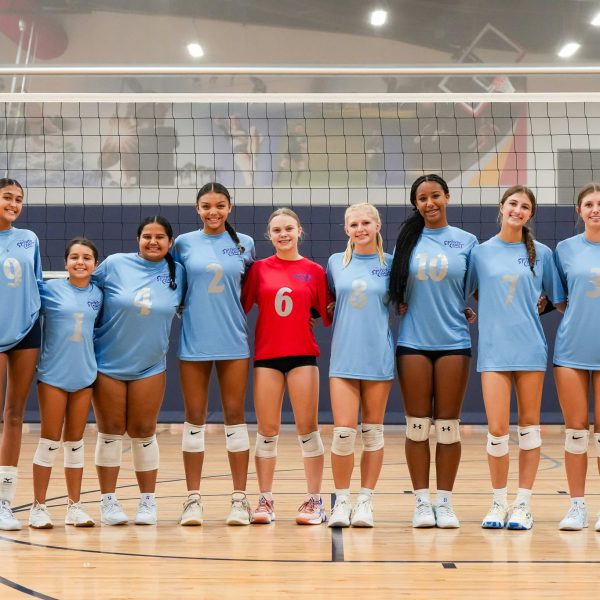 Prep and Developmental Volleyball 27 A group of women’s volleyball players smiling and posing together in their team uniforms for a photo.