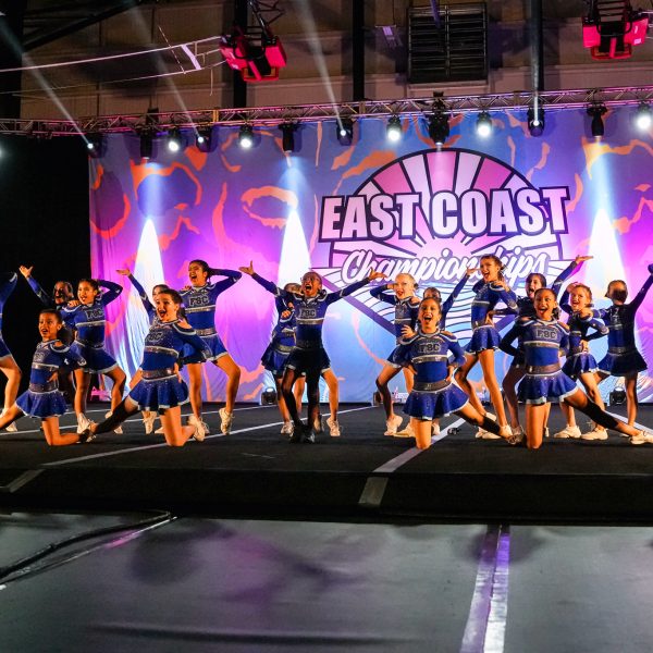 Cheerleaders execute an impressive aerial stunt during a competitive cheerleading event.