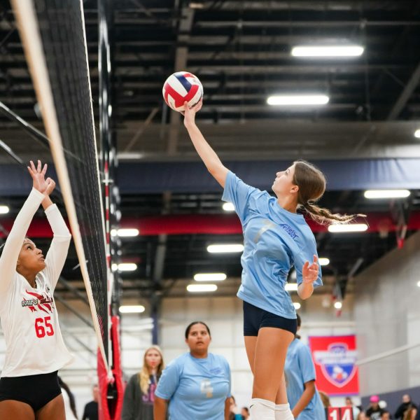 Prep and Developmental Volleyball 33 A volleyball player strikes the ball with her hand during a match, showcasing her athleticism and focus.