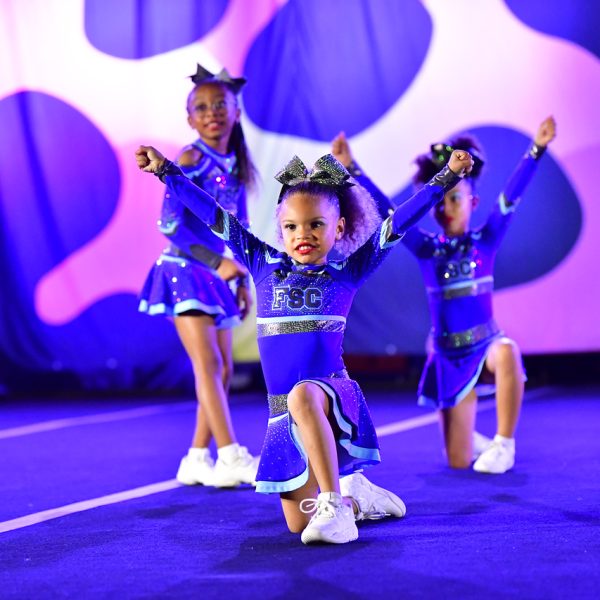 Cheerleaders execute an impressive aerial stunt during a competitive cheerleading event.