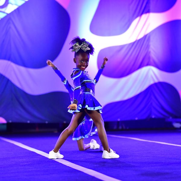 Cheerleaders execute an impressive aerial stunt during a competitive cheerleading event.