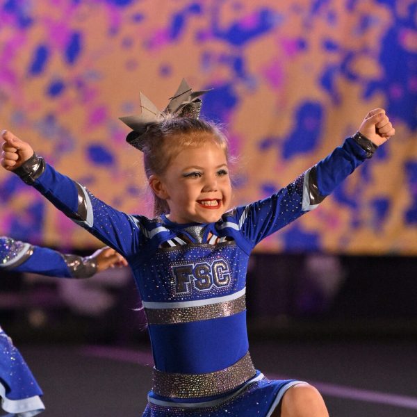 Cheerleaders execute an impressive aerial stunt during a competitive cheerleading event.